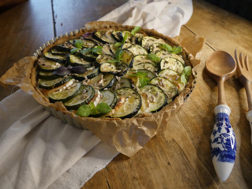 Courgette and tomato tart in a rustic dish
