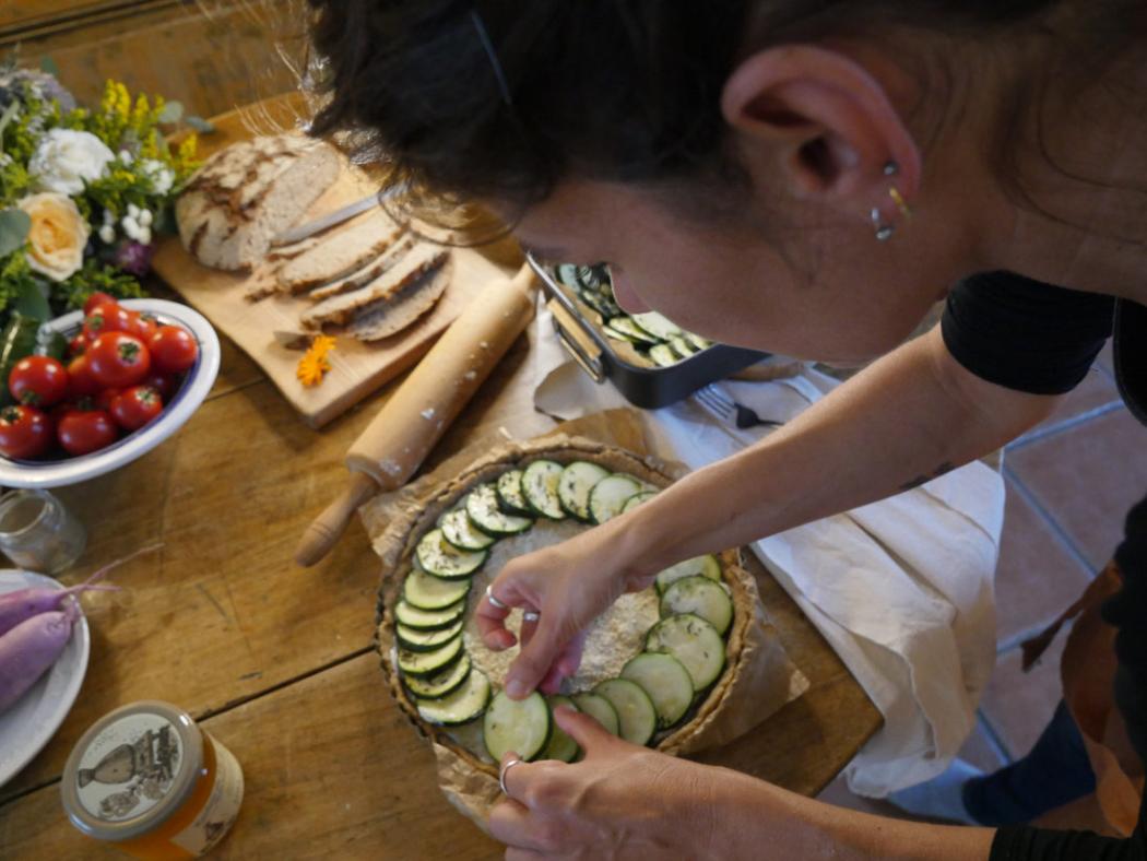 Amandine arranging a buffet with a vegetable tart
