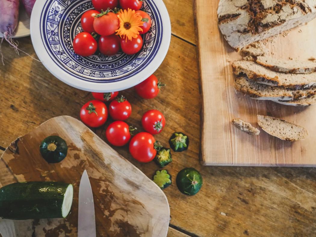 Tomatoes, courgettes and sourdough bread on a wooden table