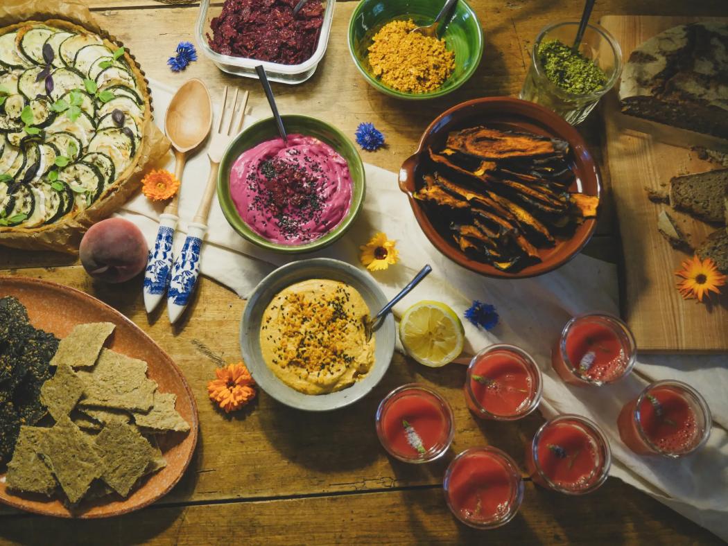 A spread of batch-cooked dishes, dips and crackers