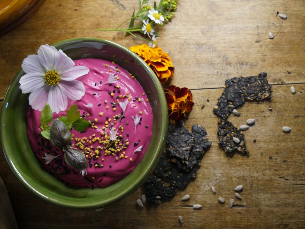 Beetroot dip with edible flowers and seeded crackers