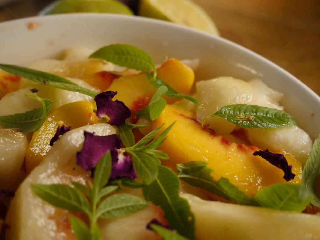 Peach and fruit salad with herbs and flowers